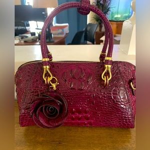 Magenta colored shoulder bag.